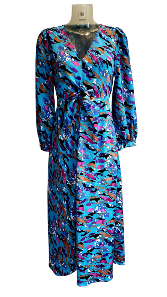 A long sleeve, multicolor floral dress displayed on a mannequin with a tie waist and V-neckline.